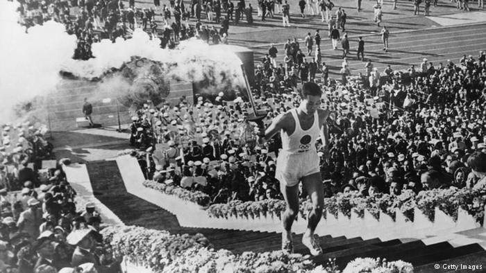 Yoshinori Sakai carries the torch into the stadium at the opening ceremony of the 1964 Olympic Games in Tokyo, Copyright: Getty Images