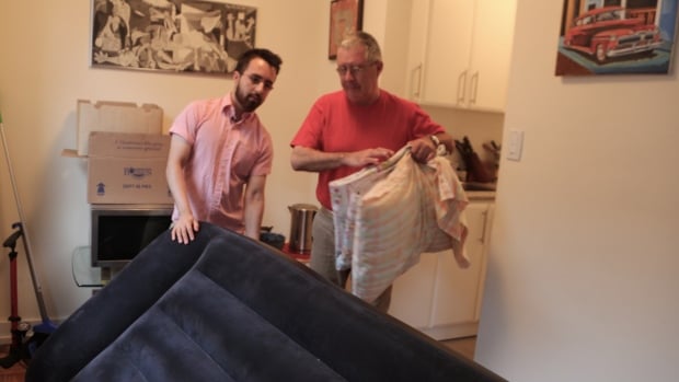 Enrique Miranda and his father set up an air mattress in Miranda's apartment after the short-term rental they had secured turned out to be a scam.